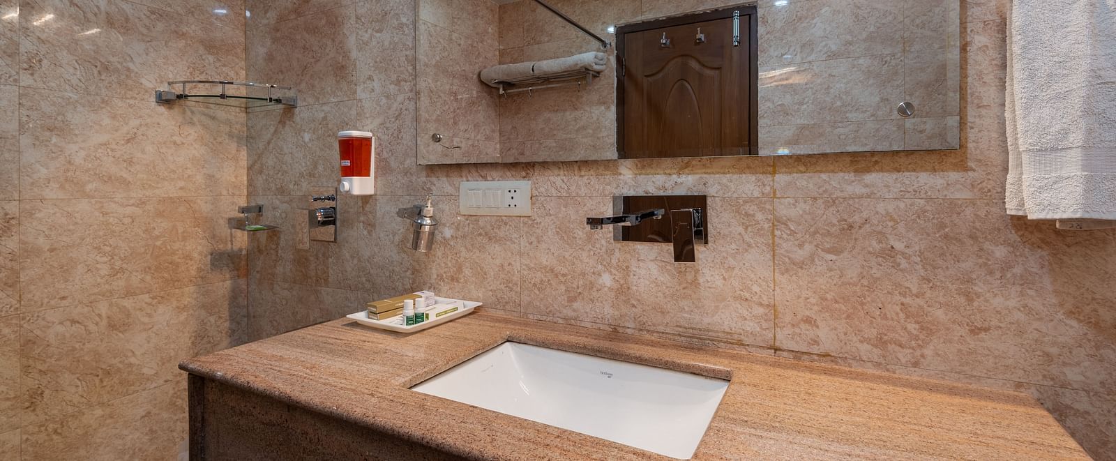 Super deluxe washroom featuring a wash basin and a mirror at DLS Hotels The Rock Castle.
